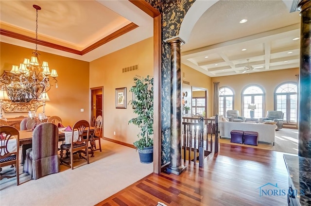 dining space with visible vents, baseboards, wood finished floors, coffered ceiling, and ornate columns