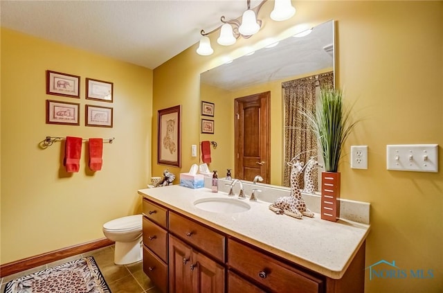 bathroom with tile patterned floors, baseboards, toilet, and vanity