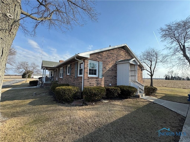 view of home's exterior with a yard and brick siding