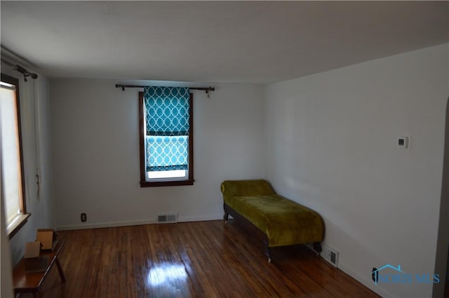 sitting room featuring visible vents and wood finished floors