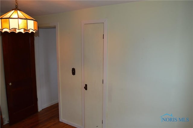 unfurnished bedroom featuring baseboards and wood finished floors