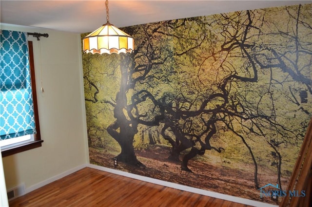 spare room with visible vents, wood finished floors, and baseboards