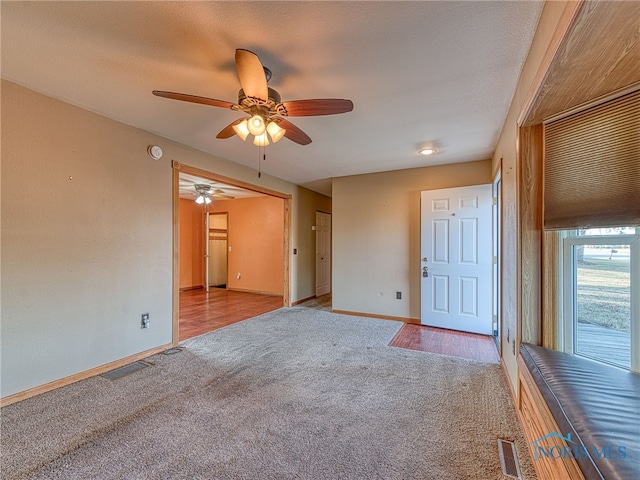 interior space featuring baseboards, visible vents, and a textured ceiling