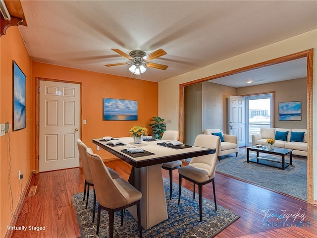 dining room with wood finished floors and a ceiling fan