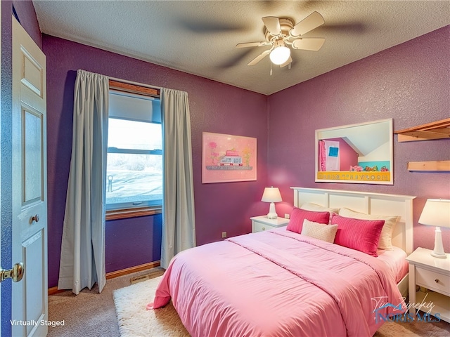 bedroom featuring carpet floors, a textured ceiling, a ceiling fan, and a textured wall