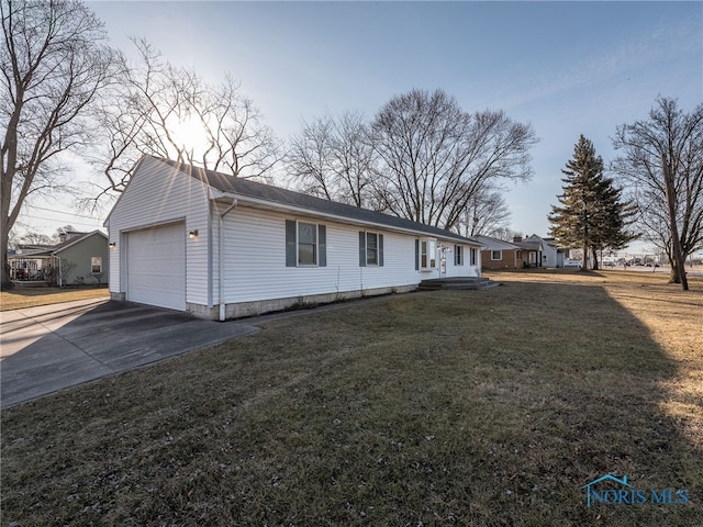 view of front of property featuring a front lawn, a garage, and driveway