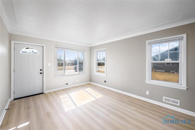 foyer entrance featuring light wood-style floors, baseboards, and visible vents