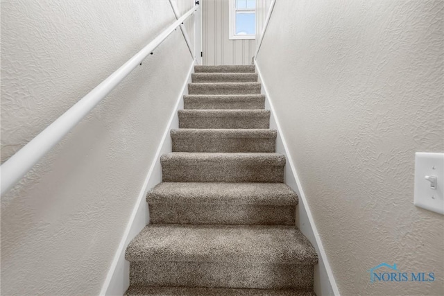 staircase with a textured wall