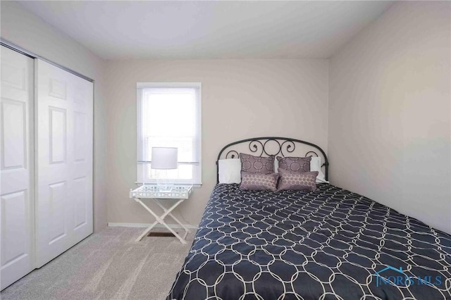 carpeted bedroom featuring a closet