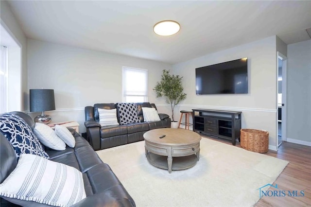 living area featuring wood finished floors and baseboards