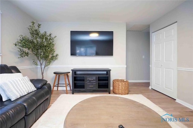 living room with baseboards and wood finished floors