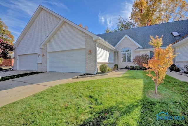 ranch-style home with brick siding, a shingled roof, a front lawn, a garage, and driveway