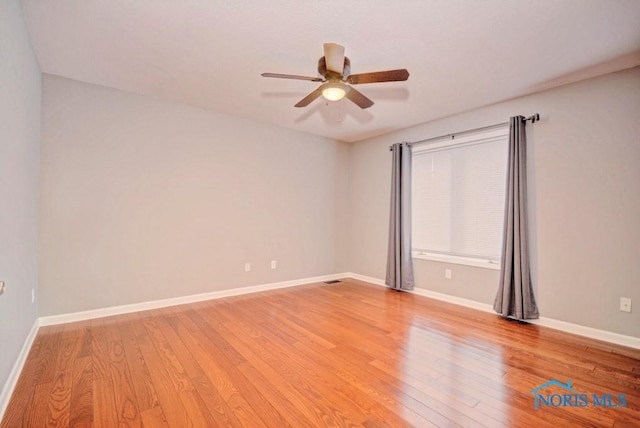 empty room with light wood-style flooring, baseboards, and ceiling fan