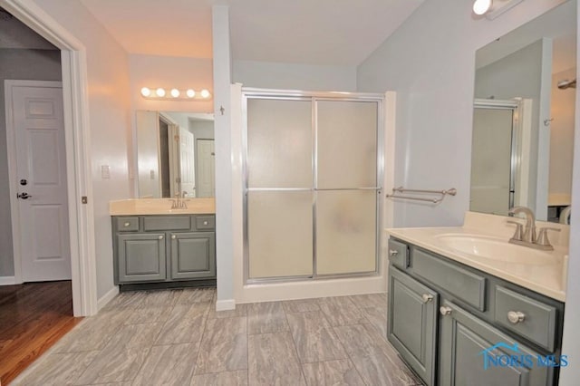 full bath with a sink and a shower stall