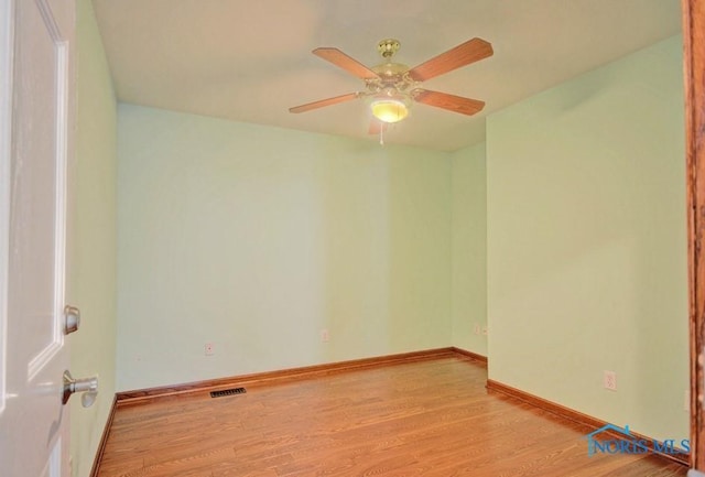 empty room with visible vents, baseboards, light wood-style floors, and a ceiling fan