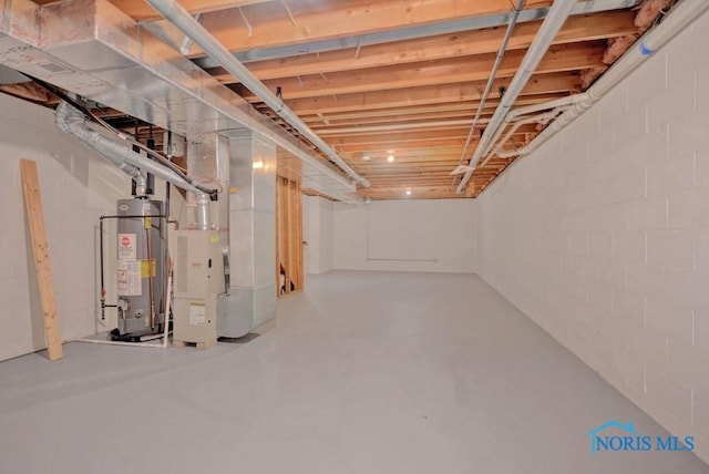 unfinished below grade area featuring water heater and heating unit