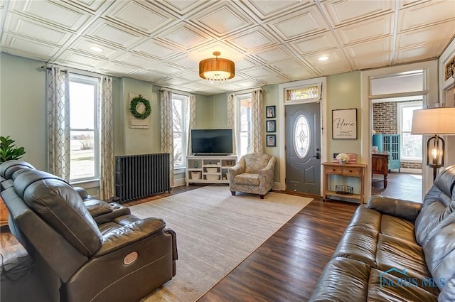 living room with recessed lighting, an ornate ceiling, baseboards, and wood finished floors