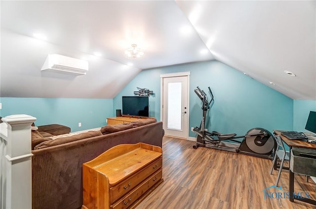 interior space featuring a wall mounted air conditioner, baseboards, lofted ceiling, and wood finished floors