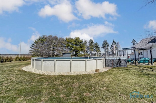 outdoor pool featuring a yard