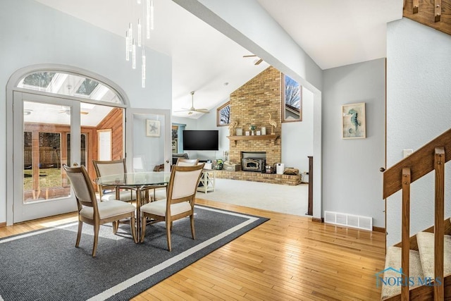 dining room with hardwood / wood-style flooring, visible vents, a wealth of natural light, and ceiling fan