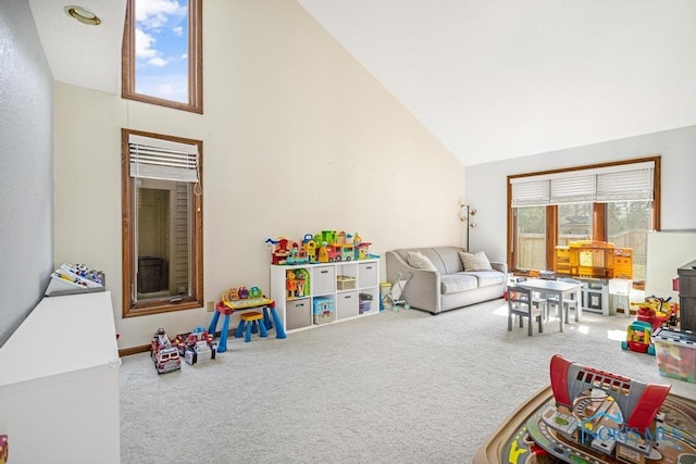 recreation room featuring carpet floors and high vaulted ceiling