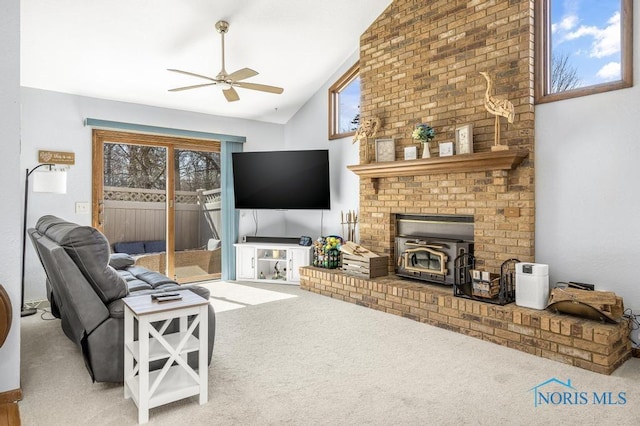 carpeted living room with a healthy amount of sunlight, a ceiling fan, and lofted ceiling