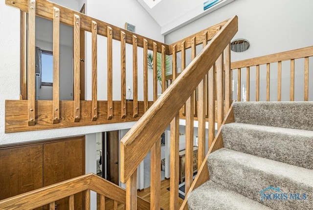 stairs with vaulted ceiling