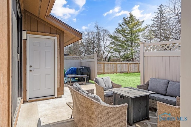 view of patio / terrace with an outdoor living space with a fire pit and fence