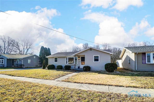 ranch-style home with a front lawn