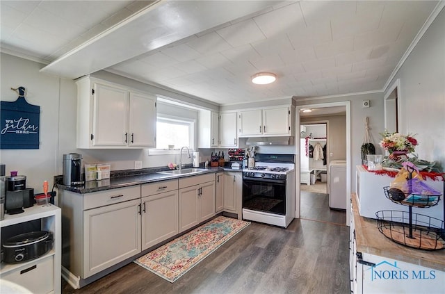 kitchen featuring dark wood-style floors, range with gas stovetop, ornamental molding, and a sink