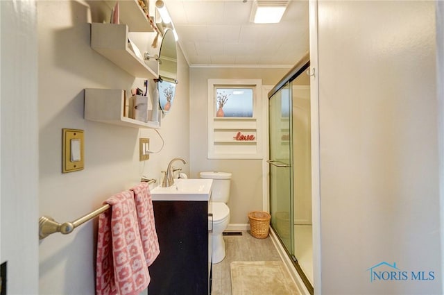 full bath featuring toilet, a stall shower, wood finished floors, crown molding, and vanity