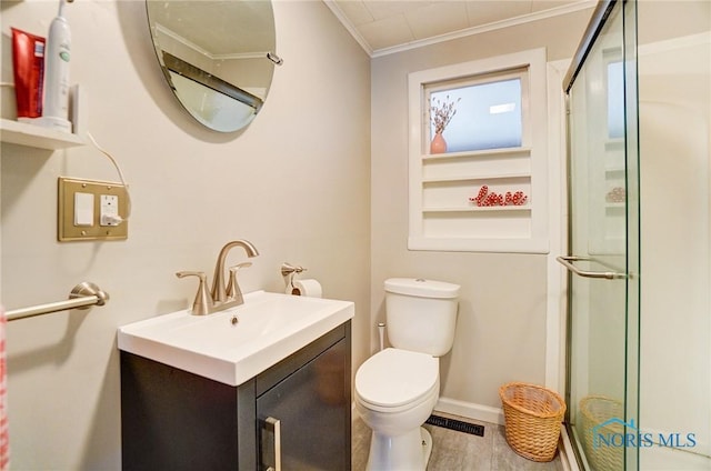 bathroom featuring vanity, visible vents, ornamental molding, a shower stall, and toilet