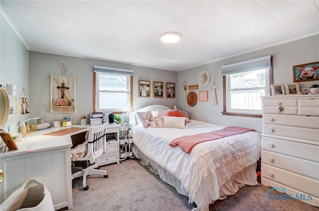 bedroom with light colored carpet and crown molding