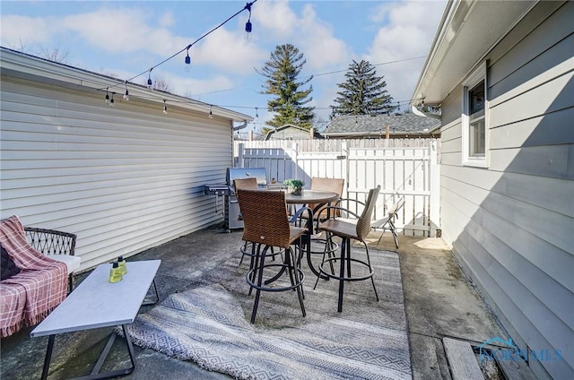 view of patio / terrace featuring outdoor dining space and fence