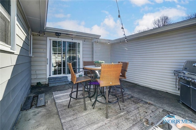 view of patio / terrace featuring outdoor dining area, area for grilling, and entry steps