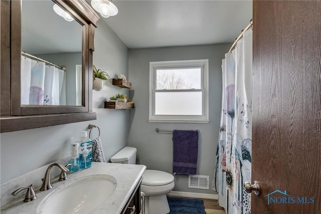 full bathroom with vanity, curtained shower, toilet, and visible vents