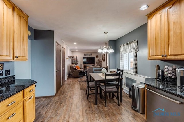 dining area featuring a notable chandelier, wood finished floors, recessed lighting, and baseboards