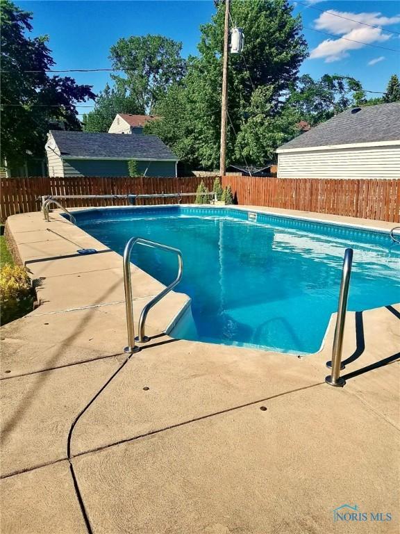 view of swimming pool with a patio area, a fenced in pool, and a fenced backyard