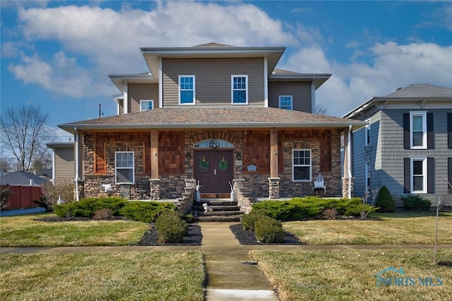 view of front facade with stone siding, a porch, a shingled roof, and a front lawn