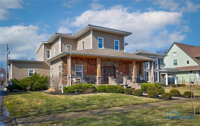 view of front of property with stone siding and a front yard