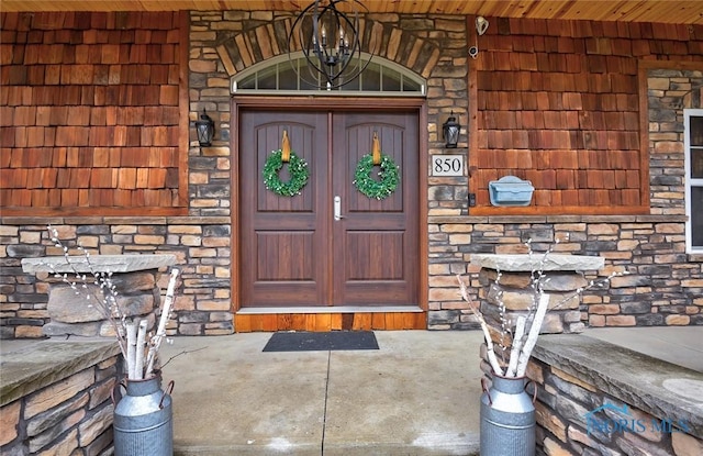 property entrance with stone siding