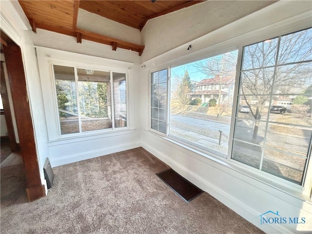 unfurnished sunroom featuring lofted ceiling, wood ceiling, and visible vents