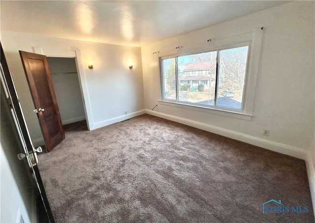 unfurnished bedroom featuring baseboards and carpet floors