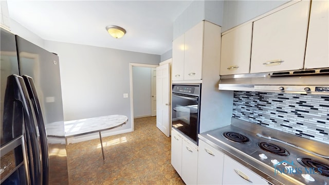 kitchen with stainless steel cooktop, range hood, freestanding refrigerator, oven, and decorative backsplash