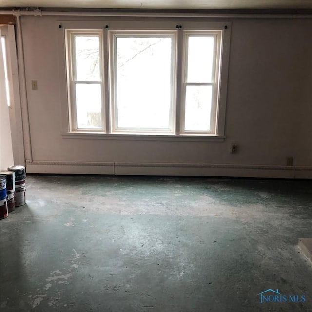unfurnished room featuring concrete floors