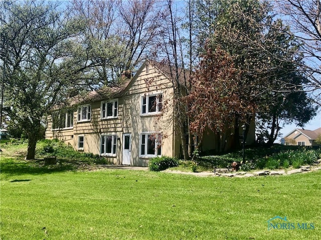 colonial inspired home with a front lawn