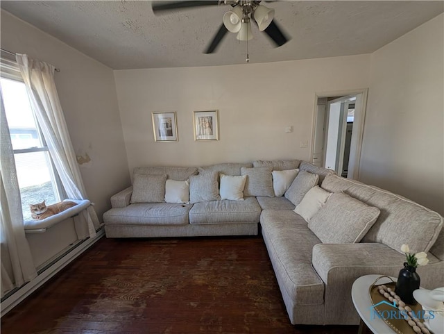 living area featuring a textured ceiling, wood finished floors, ceiling fan, and a baseboard radiator