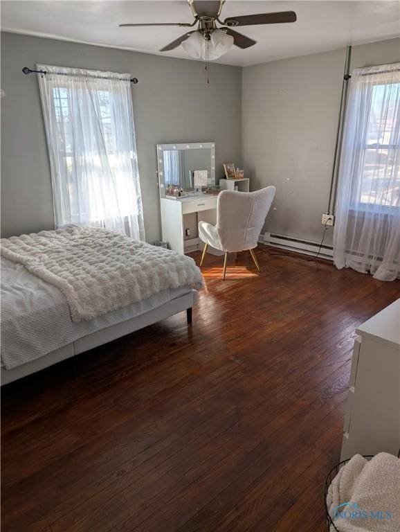 bedroom featuring wood finished floors, ceiling fan, and a baseboard radiator