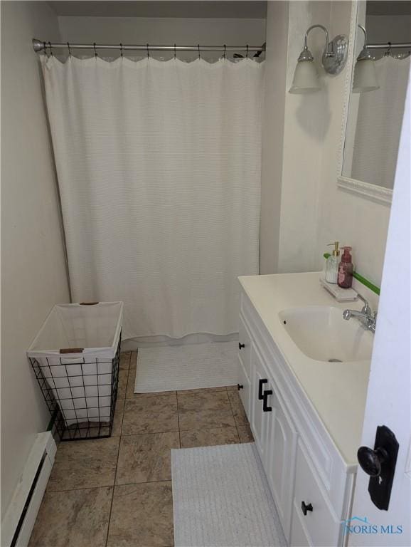 bathroom with tile patterned flooring, vanity, a shower with shower curtain, and a baseboard radiator