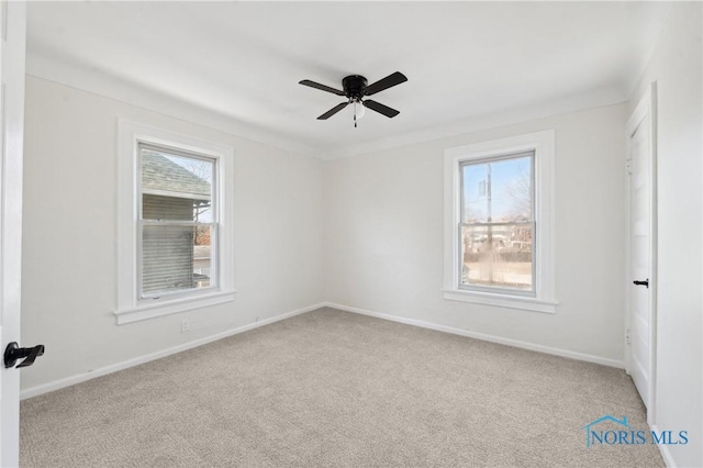 empty room featuring carpet, baseboards, and ceiling fan